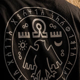 Black t-shirt with white logo and symbols on the back
