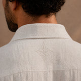 Light gray shirt with a subtle pattern on a neutral background