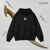 QADIM Jambiya relaxed hoodie in black, three-dagger front emblem | هودي جنبية ريلاكس أسود من قدّام
