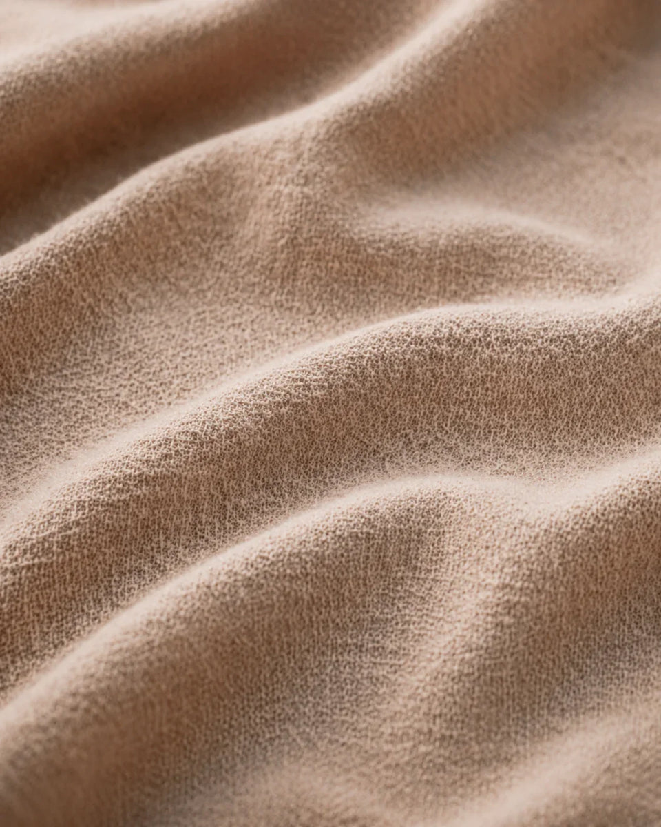 Close-up of Athar linen shirt fabric texture in natural beige by QADIM