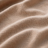 Close-up of Athar linen shirt fabric texture in natural beige by QADIM