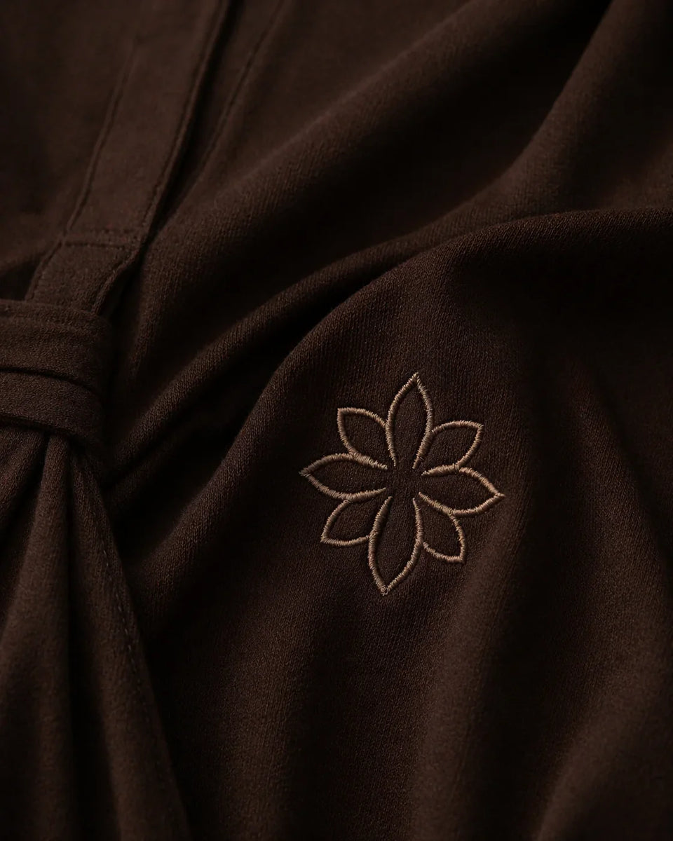 Brown fabric with a embroidered flower design on a close-up shot