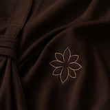 Brown fabric with a embroidered flower design on a close-up shot