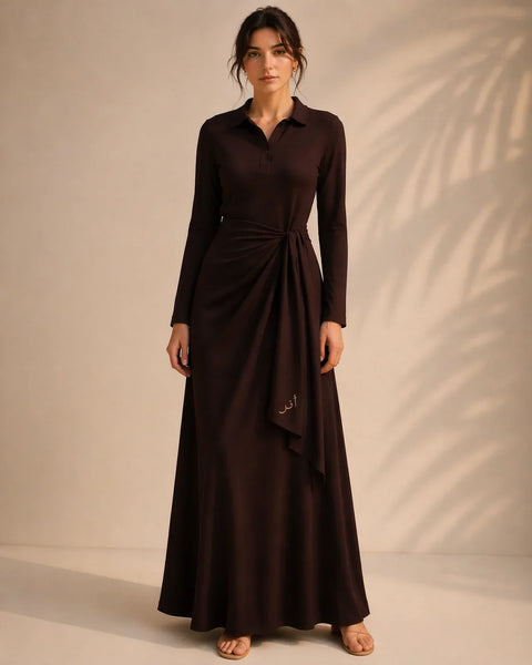 Woman wearing a long brown dress against a beige background