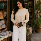 QADIM washed beige long sleeve tee at a heritage Arabic bookshop, editorial look