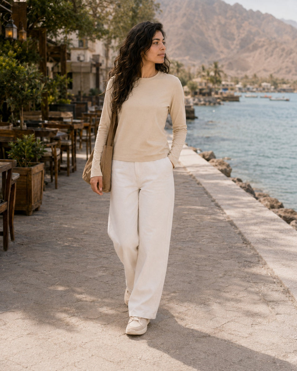 QADIM washed beige long sleeve tee, seaside promenade full look with white trousers