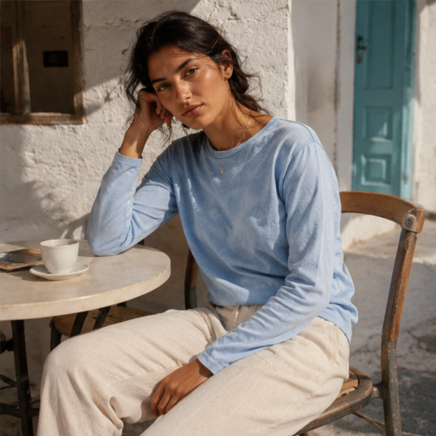 QADIM washed baby blue long sleeve tee styled seated, editorial