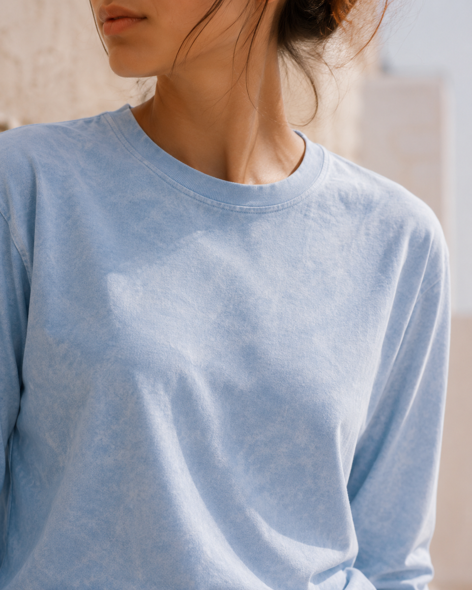 Close-up of QADIM washed baby blue long sleeve tee neckline and fabric