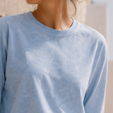 Close-up of QADIM washed baby blue long sleeve tee neckline and fabric
