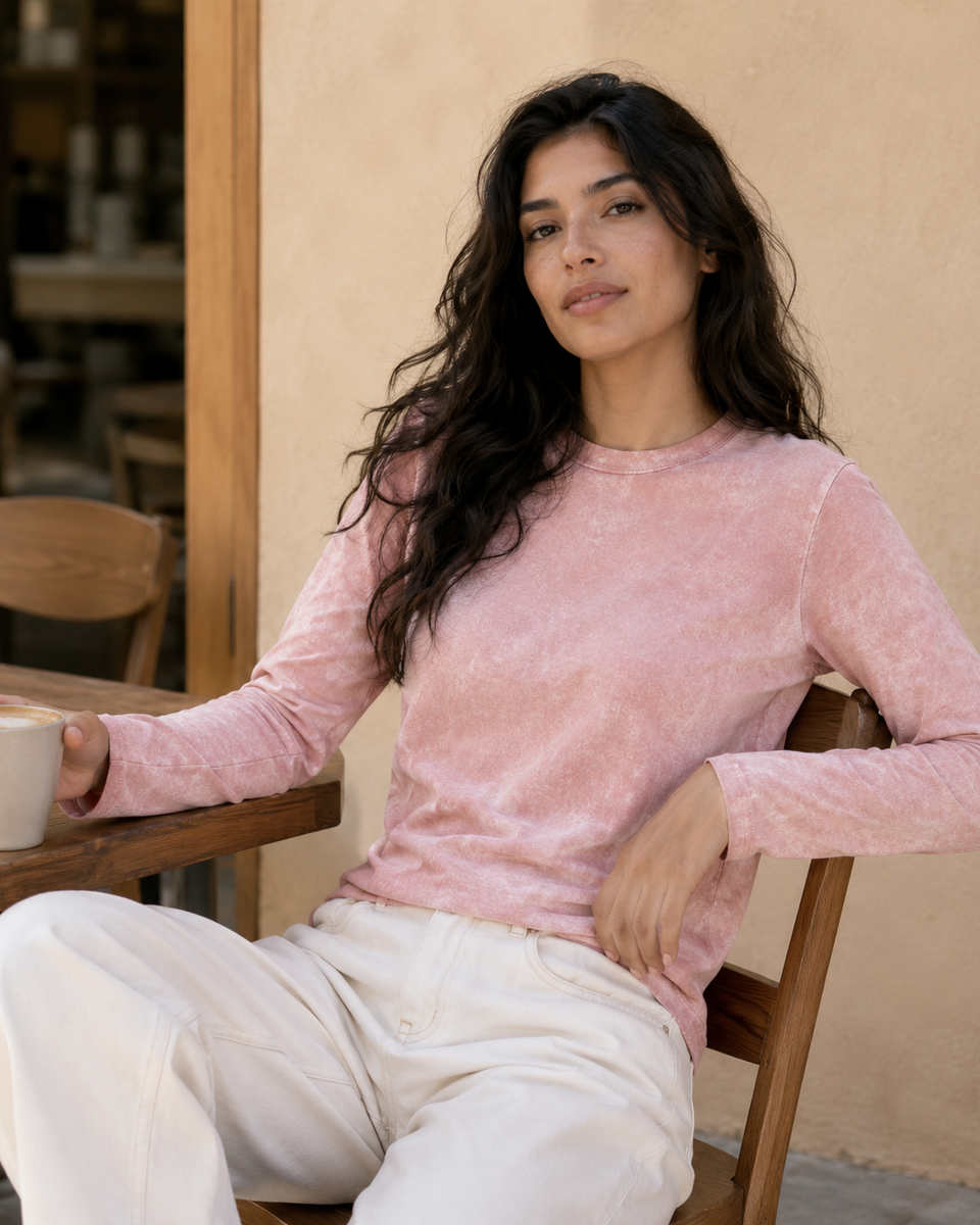 QADIM washed pink long sleeve tee styled at a cafe in warm tones