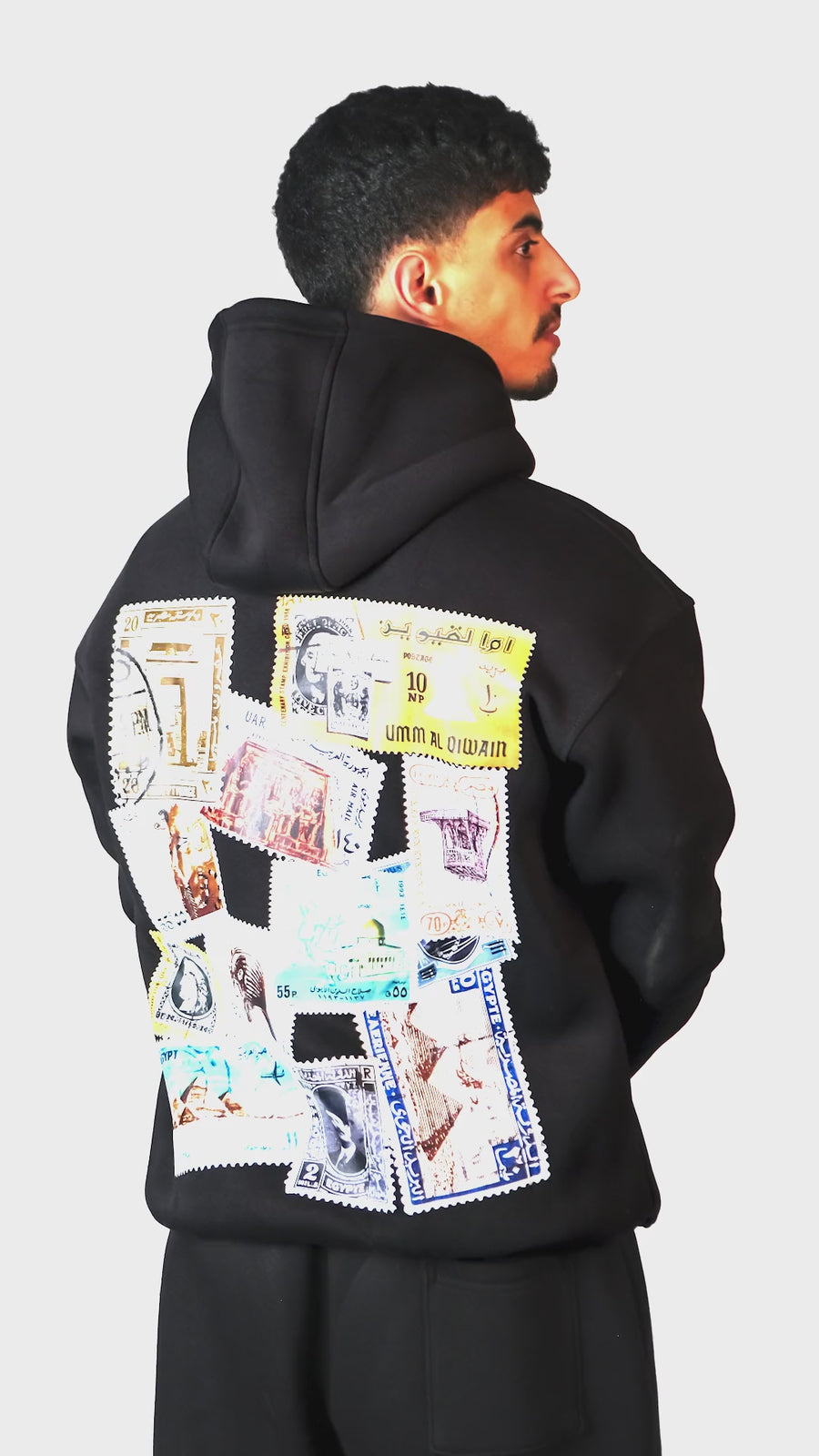 QADIM Tawabie relaxed hoodie in black, vintage stamps back print, in motion | هودي طوابع ريلاكس أسود في فيديو