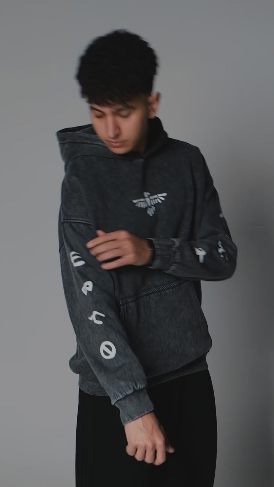QADIM 7 Eagles washed hoodie in black, eagle seal back print and sleeve symbols, in motion | هودي ٧ نسور مغسول أسود في فيديو