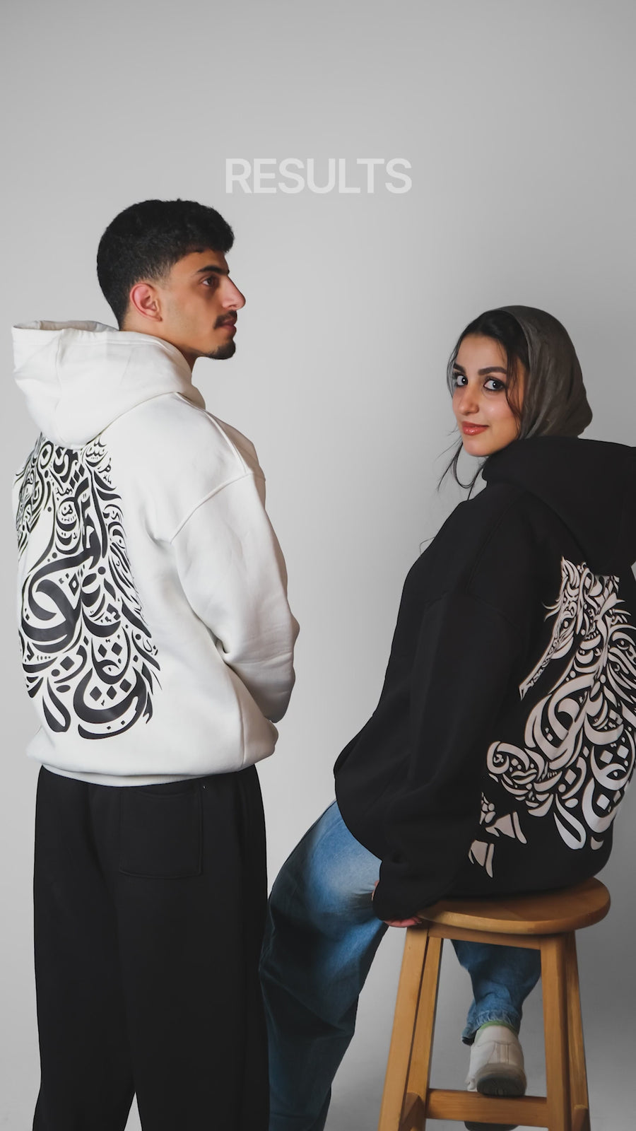 QADIM Asil relaxed hoodie in white and black, calligraphy horse back print, in motion | هودي أصيل ريلاكس أبيض وأسود في فيديو