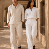 Couple walking in ATHAR Linen Relaxed Fit linen sets, Cairo heritage archway