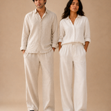 Man and woman in ATHAR Linen Relaxed Fit shirts and trousers, studio | رجل وامرأة يرتديان طقم أثر الكتان الفضفاض، تصوير استوديو
