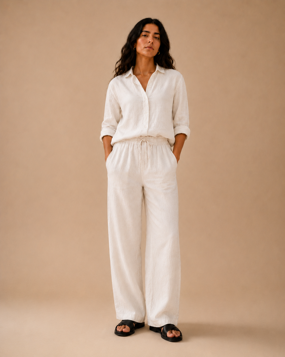 Woman wearing ATHAR Linen Relaxed Fit shirt in Off White | امرأة ترتدي قميص أثر الكتان الفضفاض بلون أوف وايت