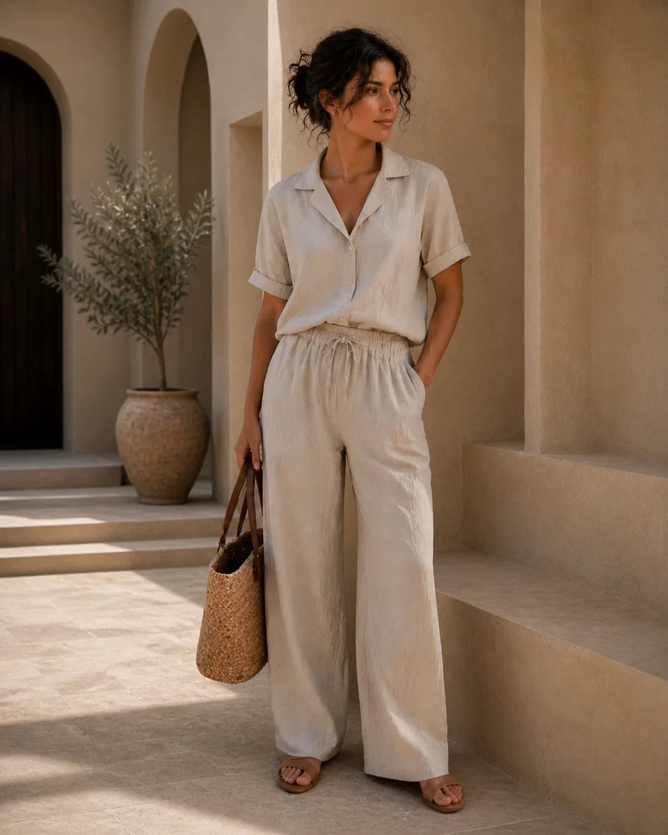 QADIM ATHAR Linen Trousers in sand styled on female model with matching linen shirt