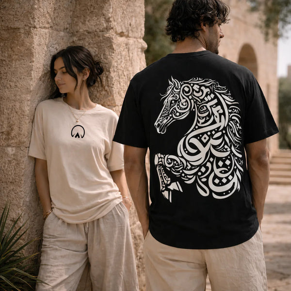 Two people wearing t-shirts with a horse design and abstract symbol.