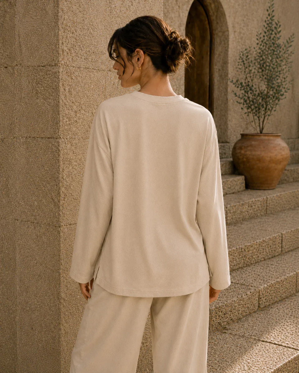 Beige long sleeve tee back view with relaxed oversized fit and soft fabric drape