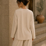 Beige long sleeve tee back view with relaxed oversized fit and soft fabric drape