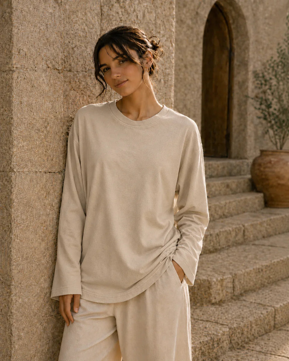 Beige long sleeve tee front view with relaxed oversized fit and soft fabric drape