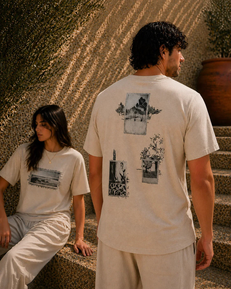 QADIM Naqsh beige half sleeve tee back artwork worn by male and female model in sunlit editorial setting