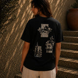 QADIM Naqsh black half sleeve tee back graphic worn by female model in warm textured stone setting