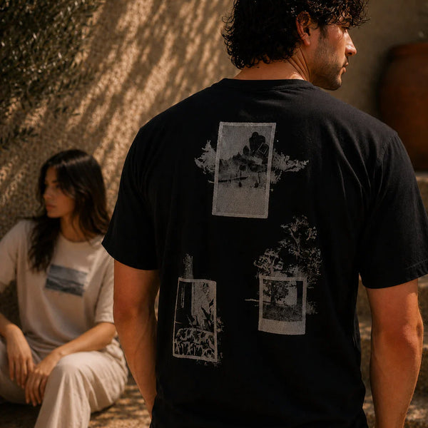 QADIM Naqsh half sleeve tee in black and beige worn by male and female models in a sunlit Mediterranean setting