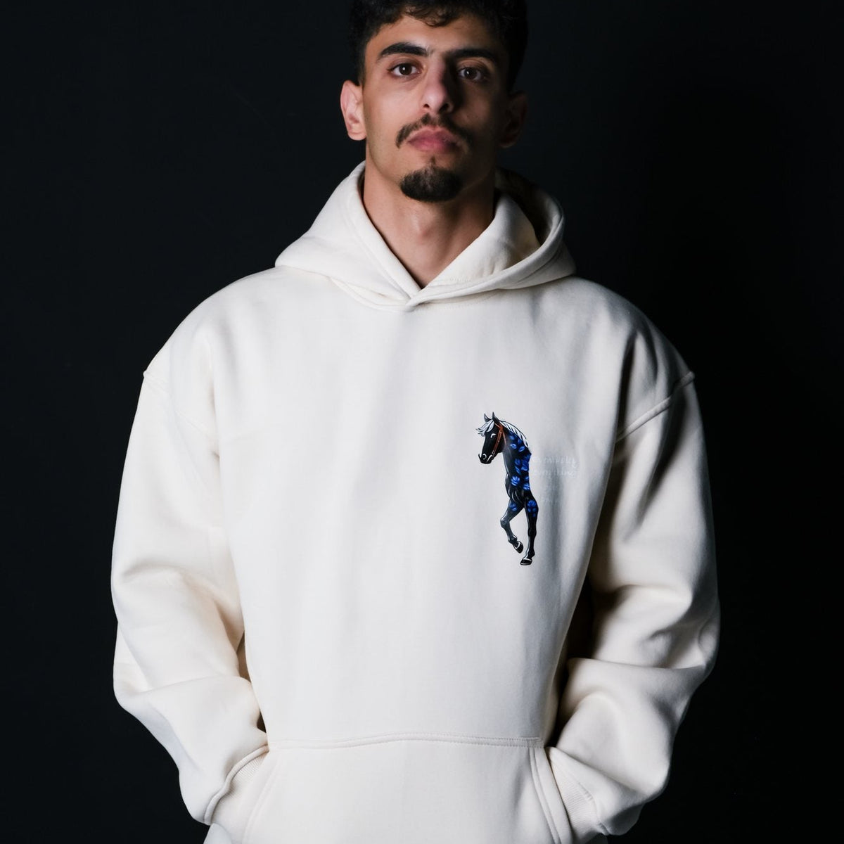 Real photo: QADIM Safar relaxed hoodie in beige, small horse on the chest | صورة حقيقية: هودي سفر ريلاكس بيج