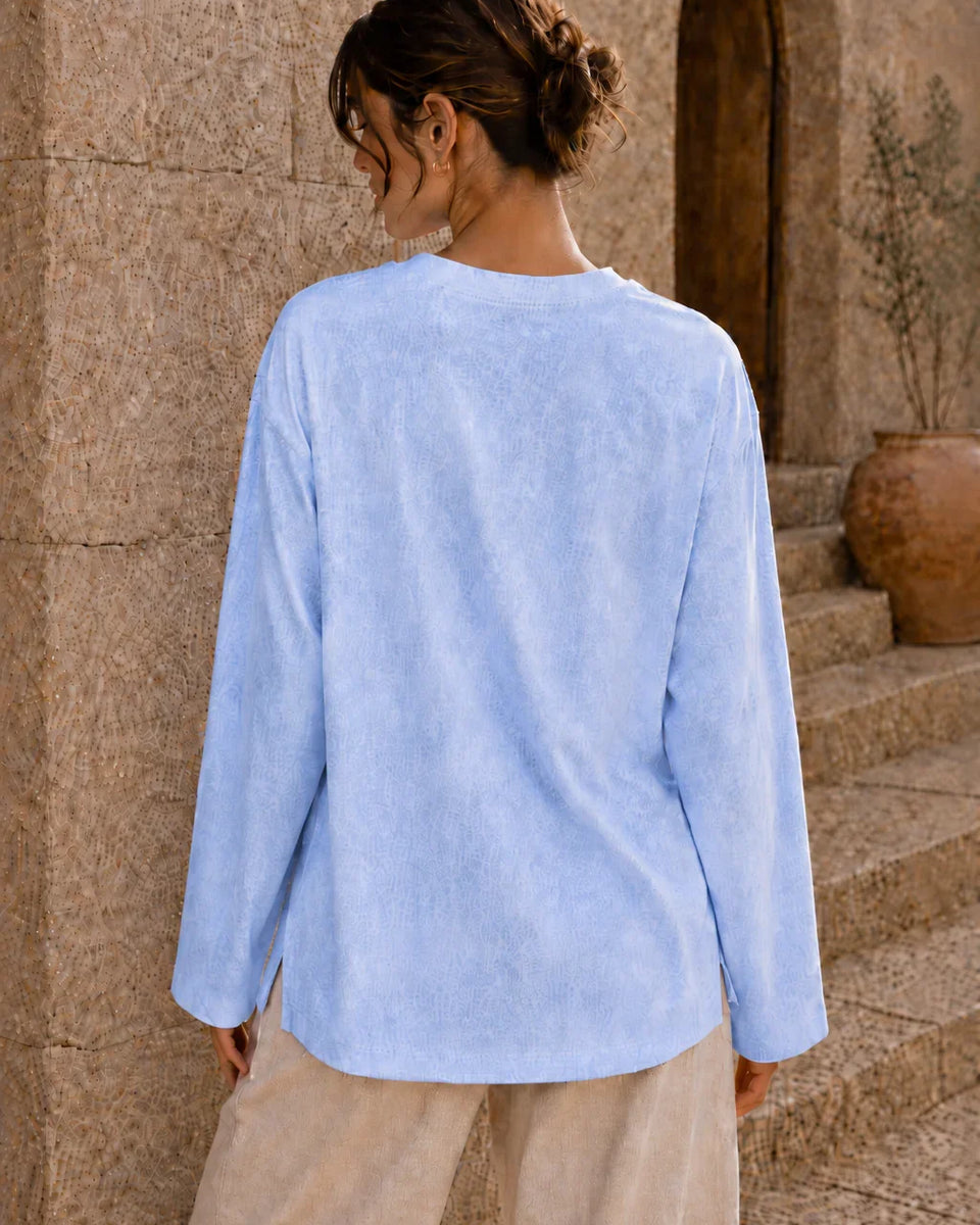 Washed baby blue long sleeve tee back view with relaxed fit and side slits