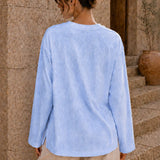 Washed baby blue long sleeve tee back view with relaxed fit and side slits