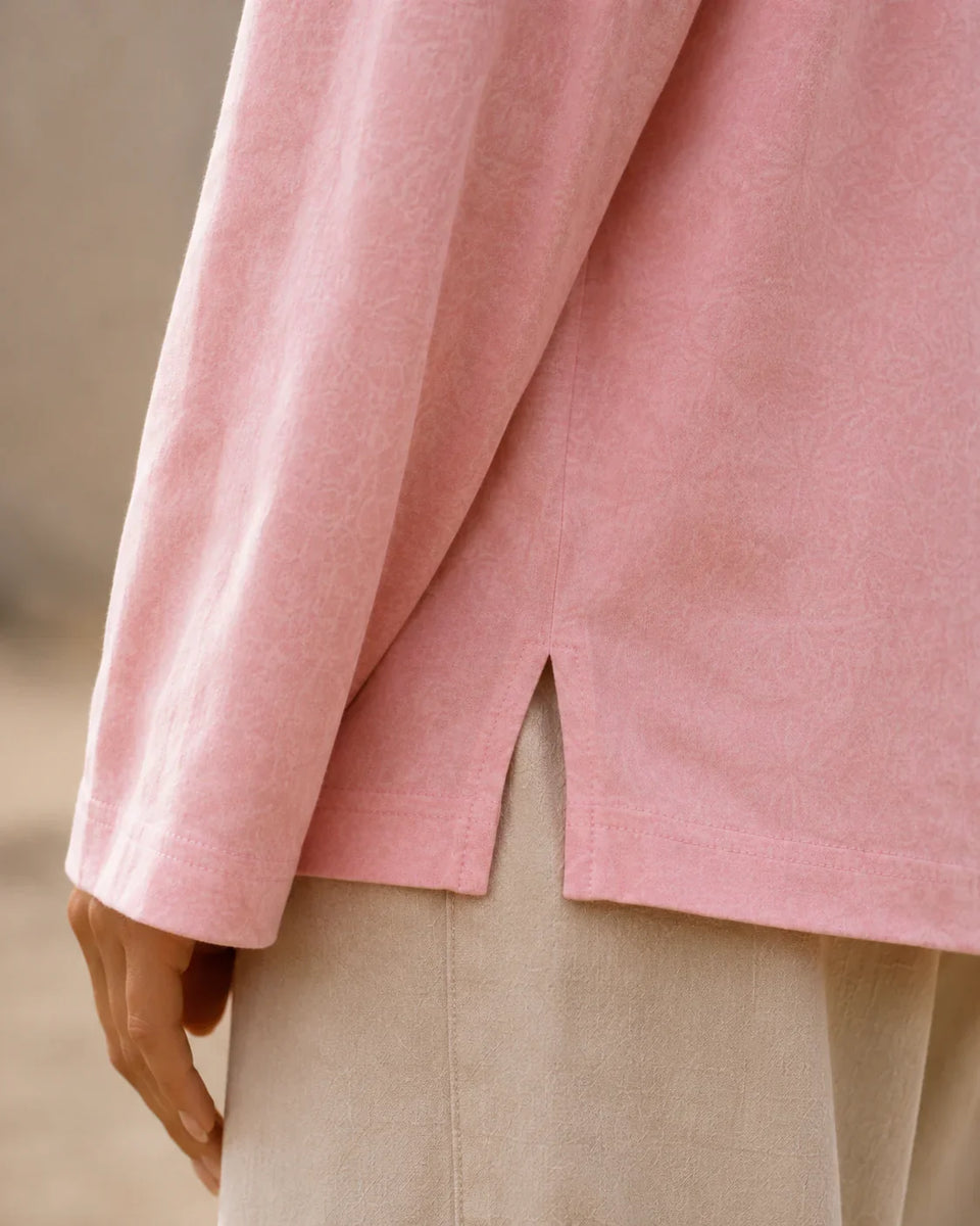 Close-up of the pink Washed Long Sleeve Tee side slit showing washed texture and soft fabric detail