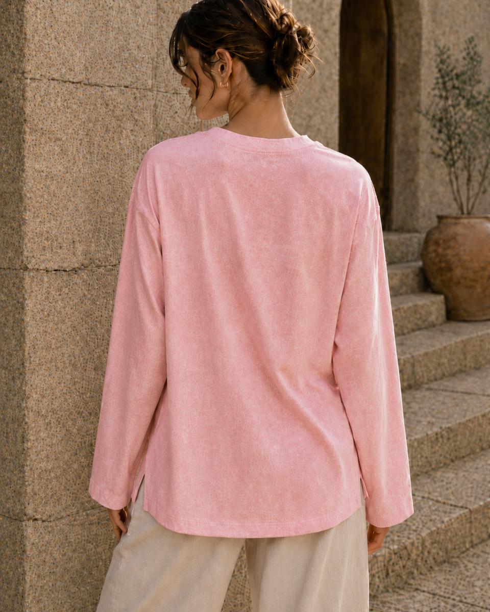 Washed pink long sleeve tee back view with relaxed fit and side slits