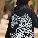QADIM Asil washed hoodie in black, calligraphy horse back print up close, with Arabian horses — @marwaabuelezz | ضهر هودي أصيل المغسول الأسود