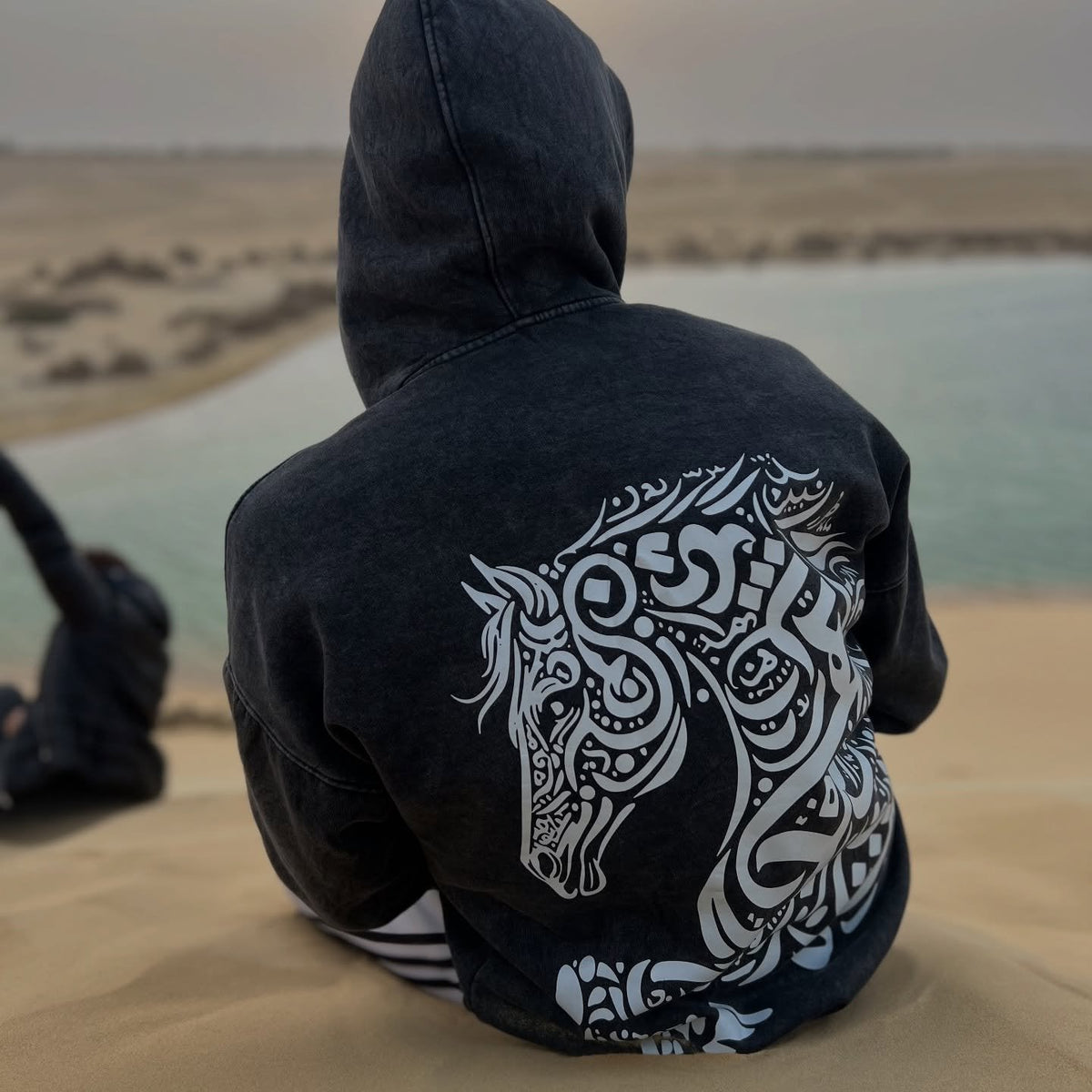 QADIM Asil washed hoodie in black, back print by the sea — @beta.mb.stunts | ضهر أصيل الأسود على البحر