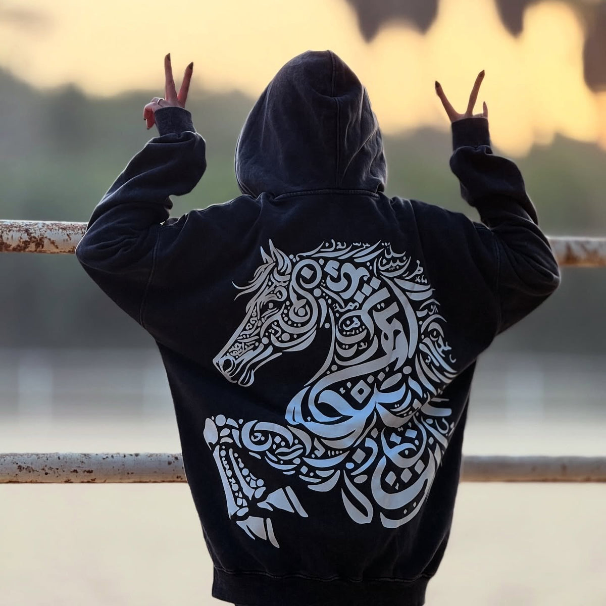 QADIM Asil washed hoodie in black, full back print at sunset — @marwaabuelezz | أصيل أسود وقت الغروب