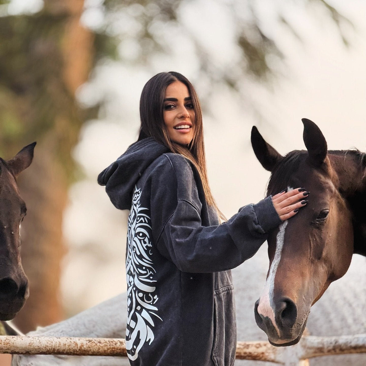 QADIM Asil washed hoodie in black, side view with horses — @marwaabuelezz | أصيل أسود مع الخيل