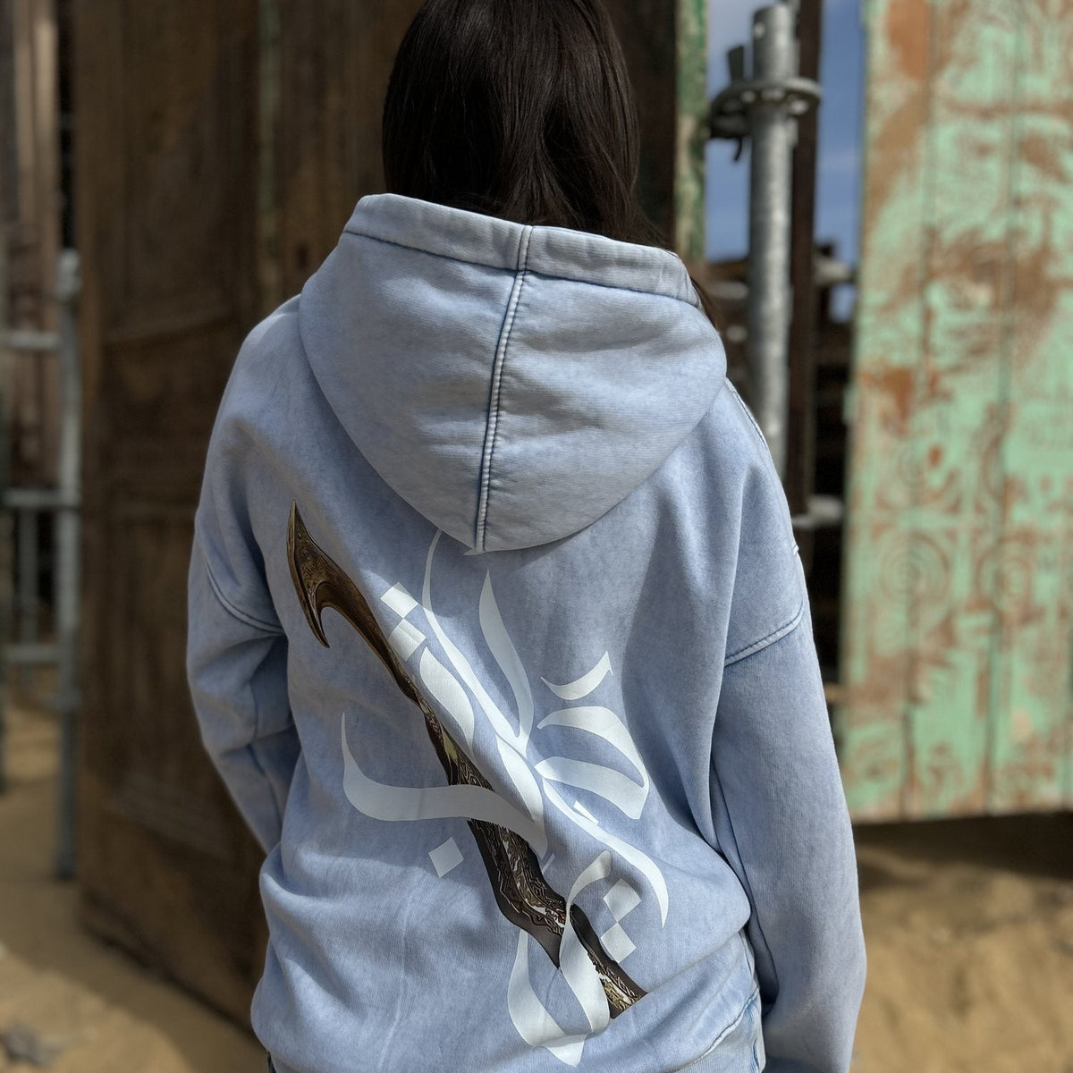 QADIM Jambiya washed hoodie in baby blue, back print, desert | ضهر هودي جنبية البيبي بلو في الصحرا