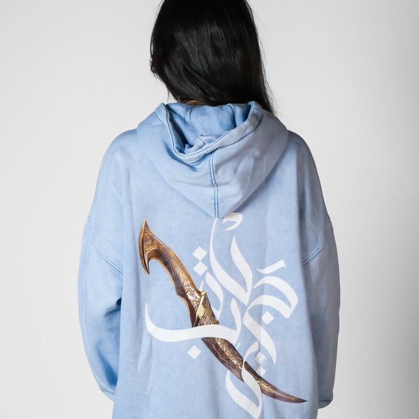 QADIM Jambiya washed hoodie in baby blue, dagger and calligraphy back print | ضهر هودي جنبية المغسول البيبي بلو