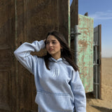QADIM Jambiya washed hoodie in baby blue, front, desert doors | هودي جنبية مغسول بيبي بلو في الصحرا