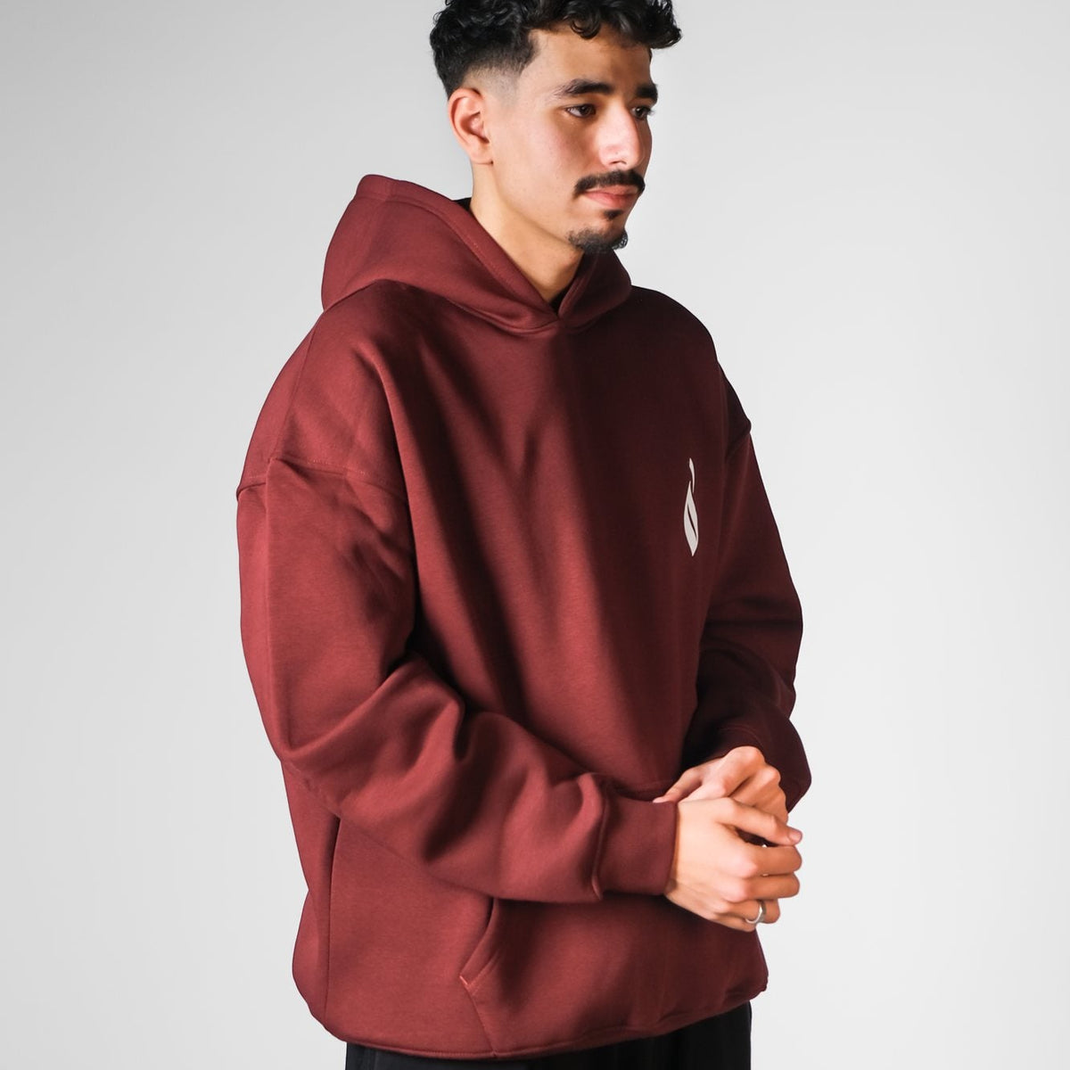 QADIM Sahm relaxed hoodie in burgundy, three-quarter view | هودي سهم ريلاكس نبيتي