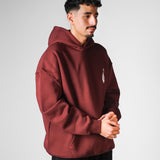 QADIM Sahm relaxed hoodie in burgundy, three-quarter view | هودي سهم ريلاكس نبيتي
