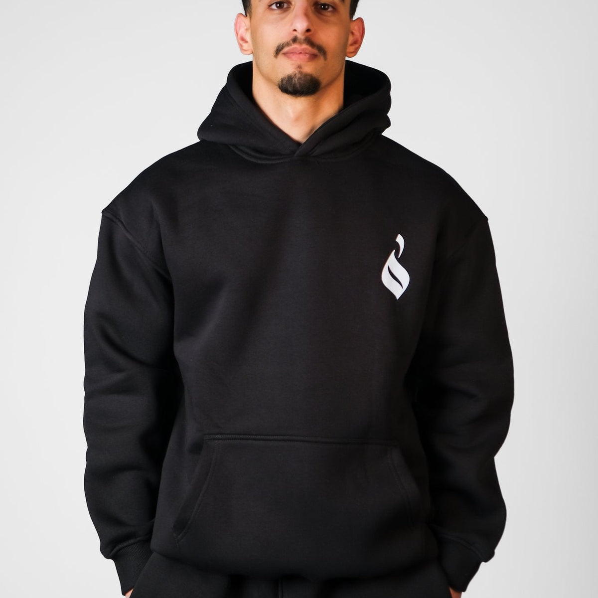 QADIM Tawabie relaxed hoodie in black, front emblem | هودي طوابع ريلاكس أسود من قدّام