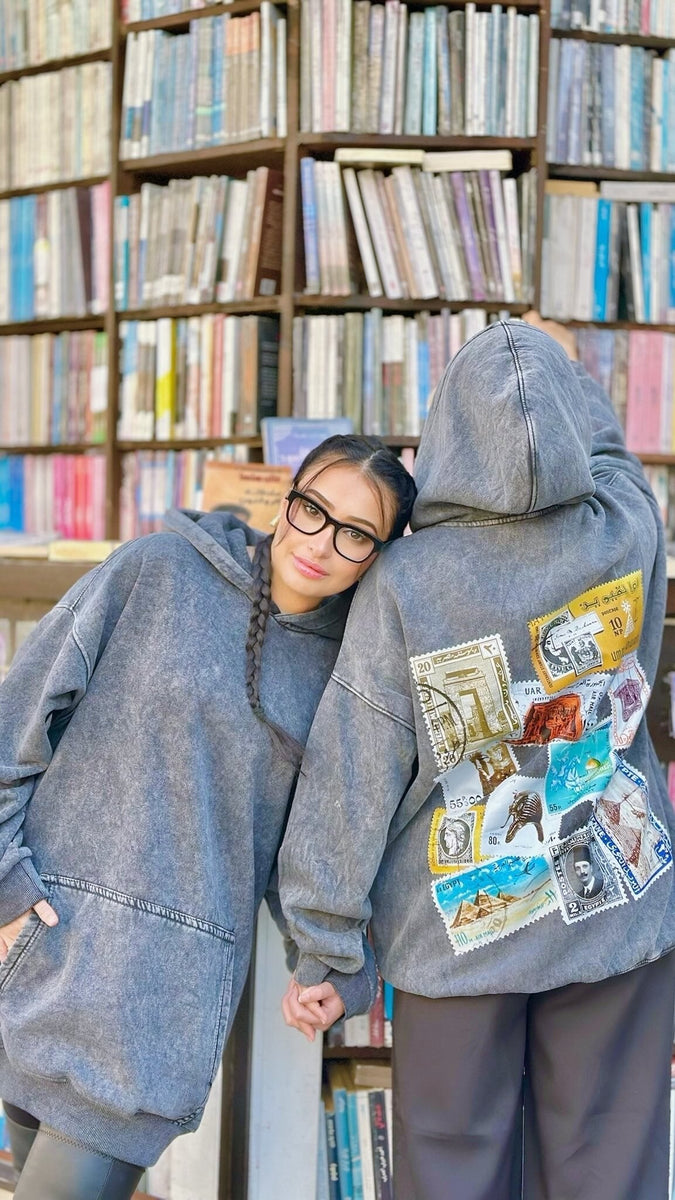QADIM Tawabie washed hoodie in baby blue in a bookshop — @talolaishere | طوابع مغسول بيبي بلو