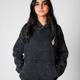 QADIM Tawabie washed hoodie in black, front, female model | هودي طوابع مغسول أسود على موديل بنت