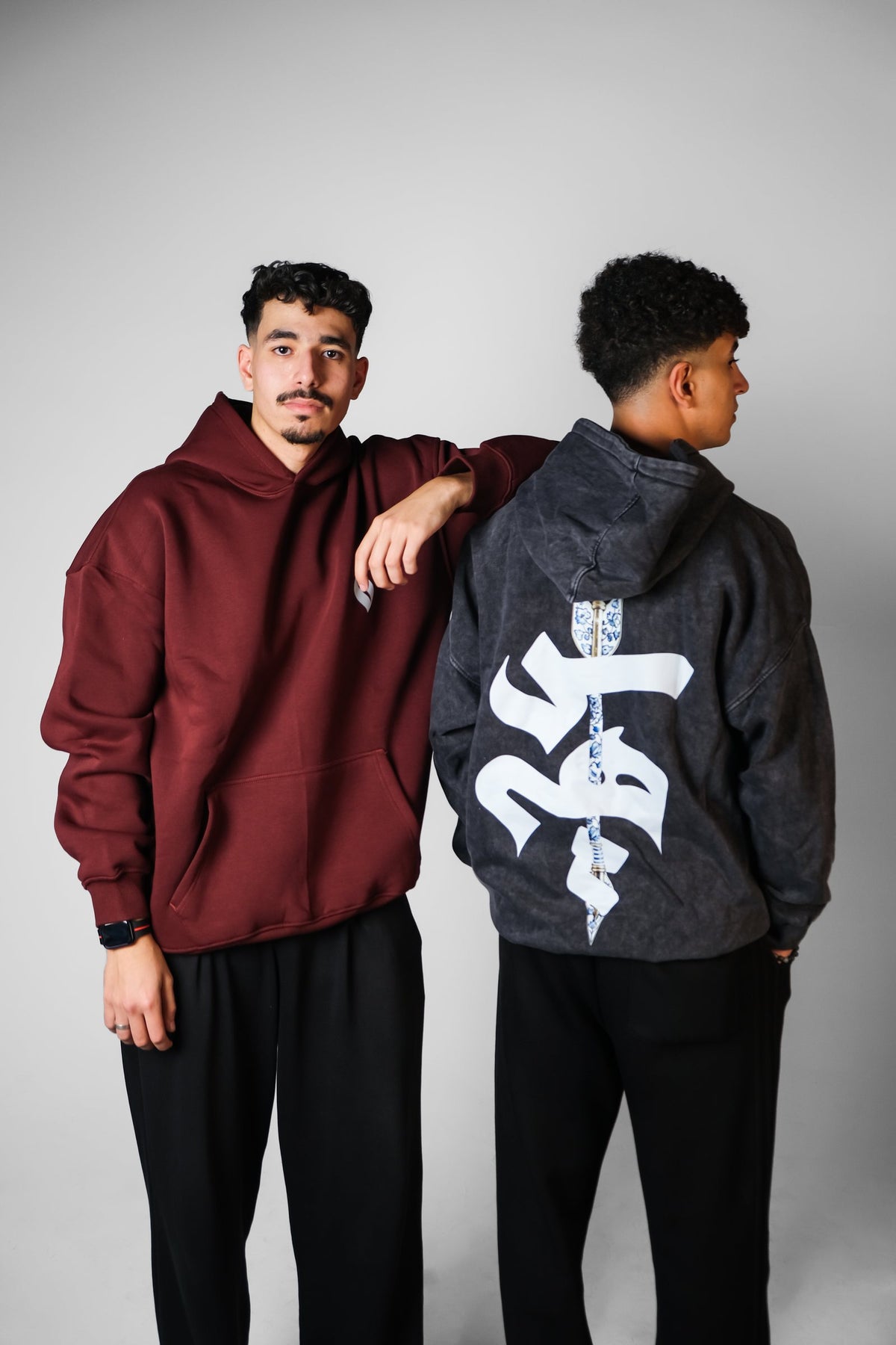 QADIM relaxed hoodie in burgundy and washed hoodie in black with calligraphy back print